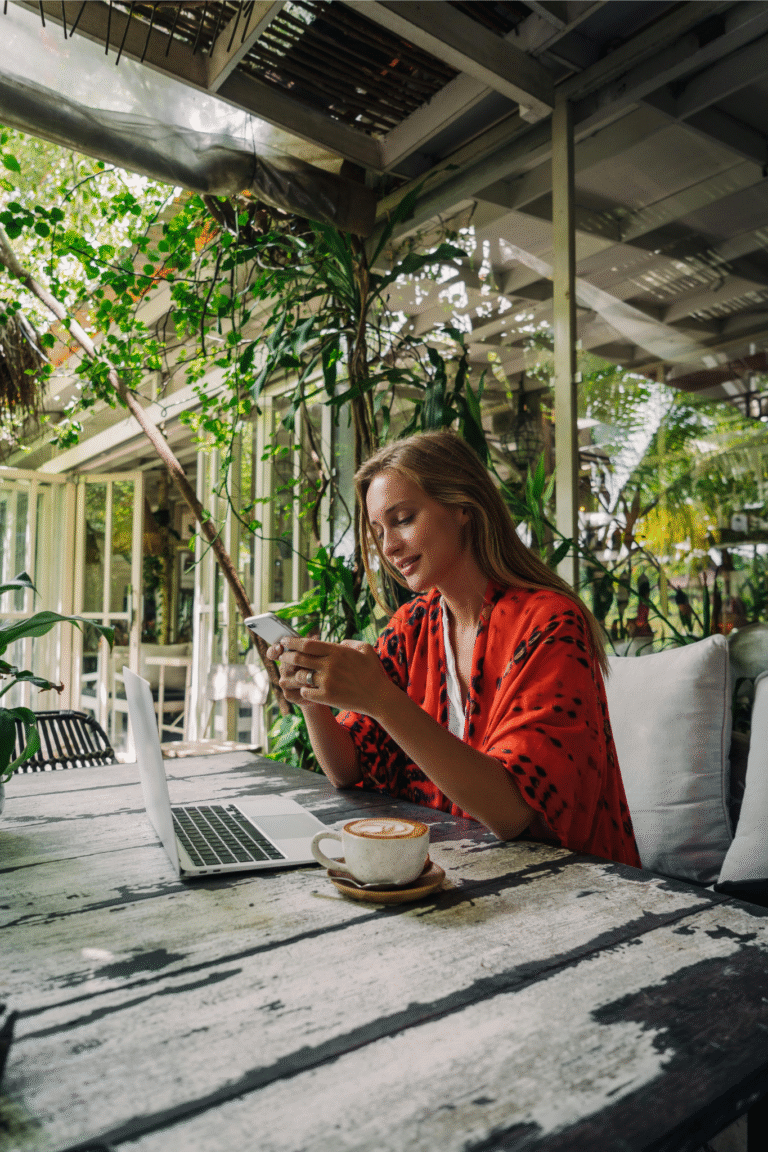 Digital nomad working remotely from a beach café