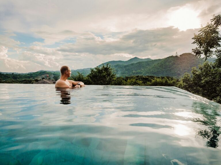 Digital nomad working remotely on a laptop in a tropical outdoor setting