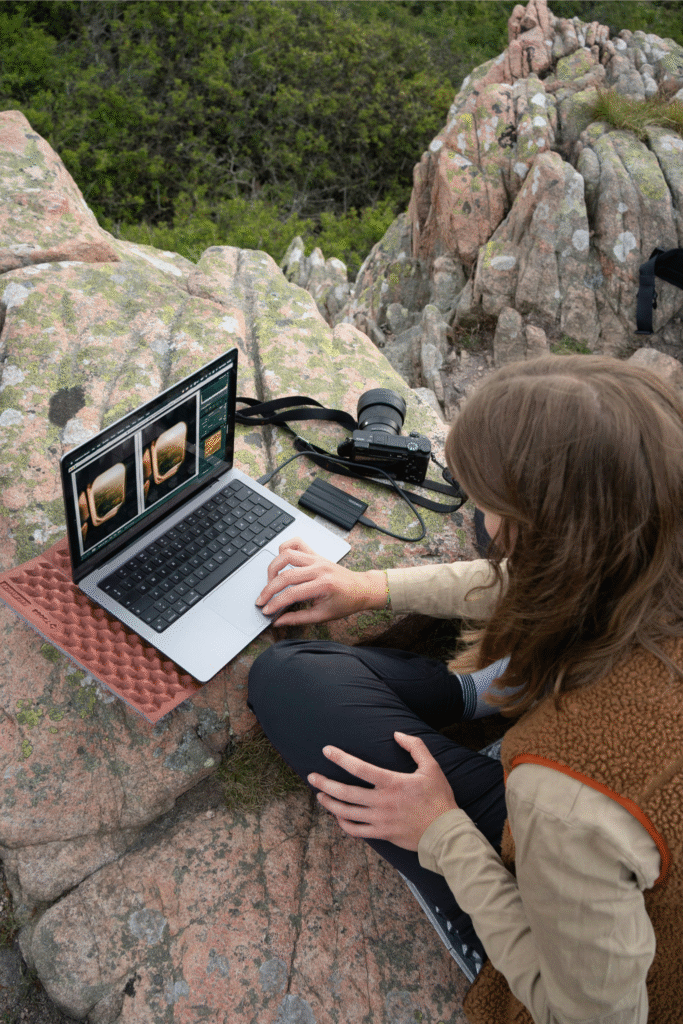 Digital nomad working outdoors with laptop and remote gear