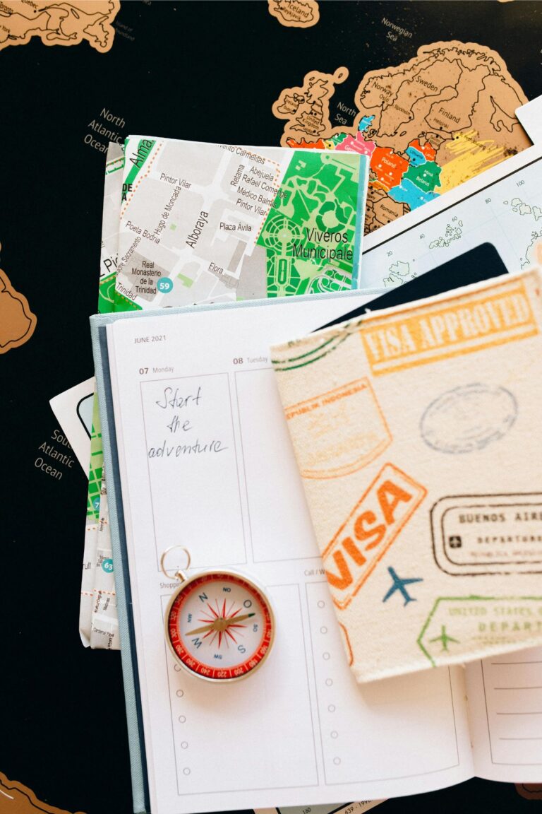 Passport with digital nomad visa next to a laptop and application form