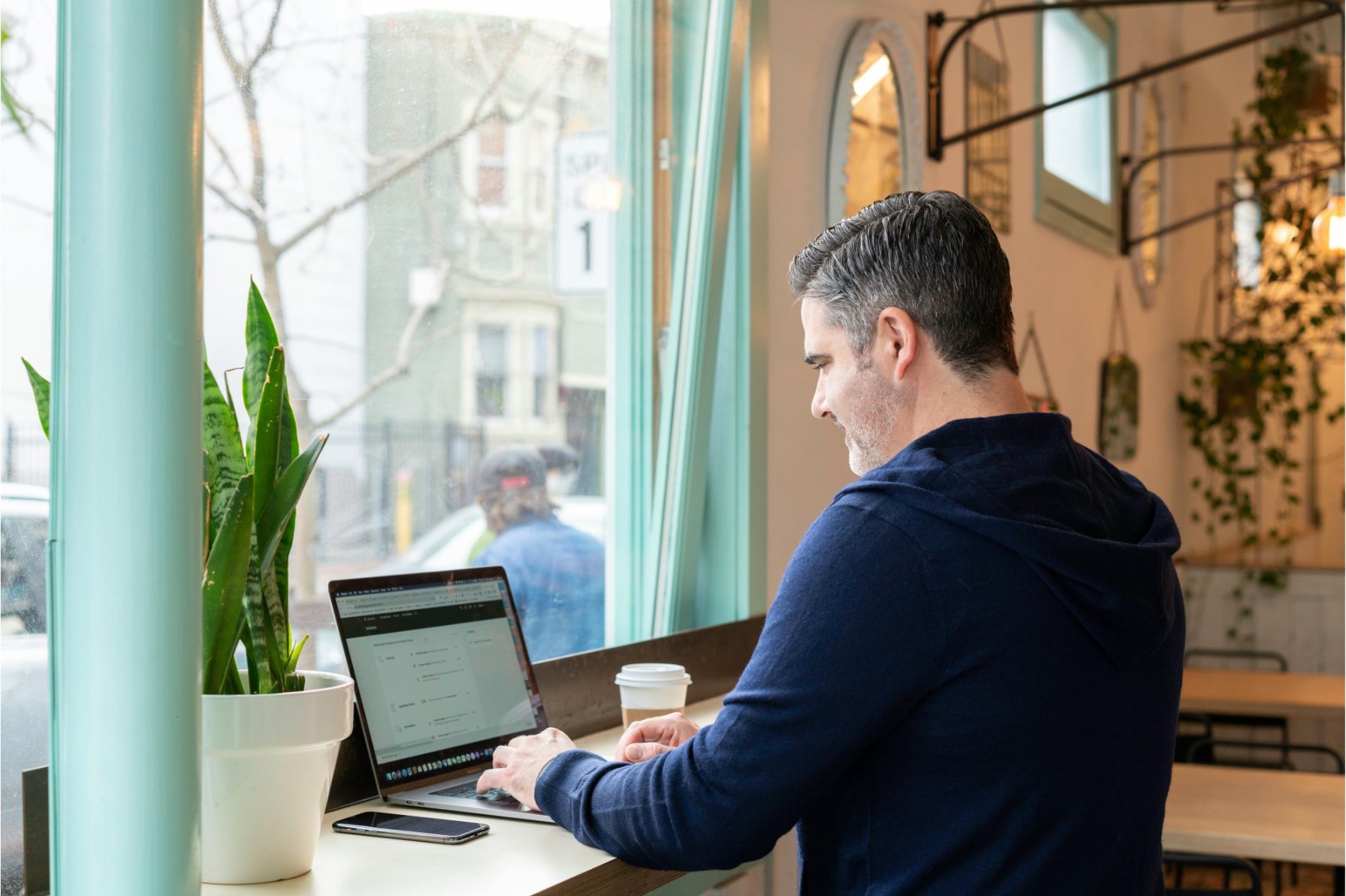 remote worker with laptop overlooking affordable city